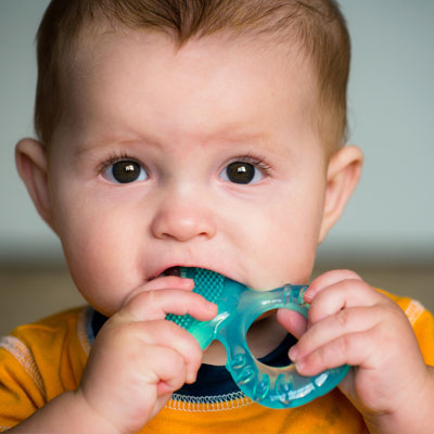 Baby biting a teether toy